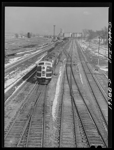 A westbound Atchison, Topeka and Santa Fe Railroad diesel freight train pulling out of a railroad yard. It consisted of 100 cars, about 6000 tons