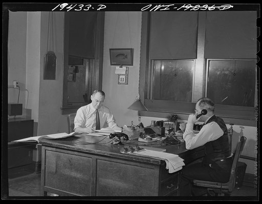 Argentine, Kansas City, Kansas. Night trainmaster A. G. Hodgins, right, and train clerk F. E. Hashman, at work in assistant trainmaster's office