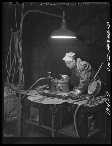 Untitled photo, possibly related to: Shopton, near Fort Madison, Iowa. At the Atchison, Topeka and Santa Fe Railway diesel head shop, a diesel cylinder head being heated in a brick oven before welding cracks it