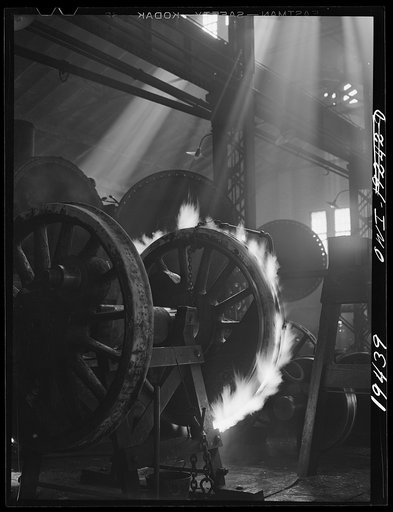 Shopton, near Fort Madison, Iowa. Retiring a locomotive driver wheel in the Atchison, Topeka and Santa Fe Railway locomotive shops. The tire is heated until it expands sufficiently to be slipped onto the wheel. Contraction on cooling will hold it firmly in place