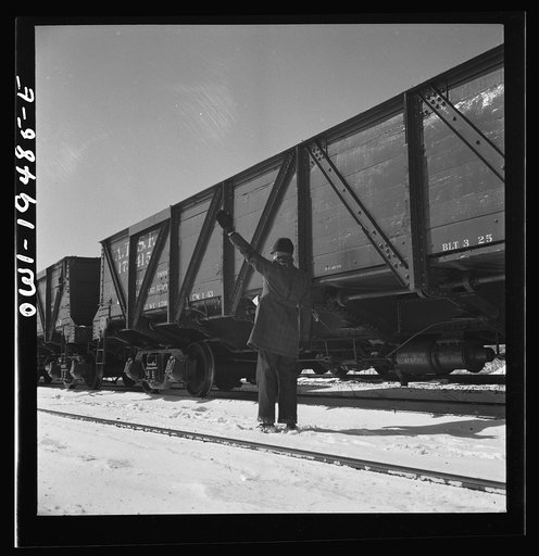 Joilet, Illinois. Conductor giving the brakeman the signal to apply and release the brakes before the train leaves on the Atchison, Topeka and Santa Fe