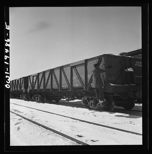 Untitled photo, possibly related to: Joilet, Illinois. Conductor giving the brakeman the signal to apply and release the brakes before the train leaves on the Atchison, Topeka and Santa Fe