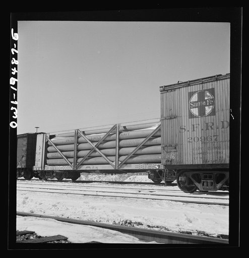 Untitled photo, possibly related to: Dahinda, Illinois. On the Atchison, Topeka and Santa Fe Railroad between Chillicothe, Illinois to Fort Madison, Iowa, a coupling pin jumps loose and the train breaks in two. The conductor, riding on top of the train, signals the engineer as they back up in order 