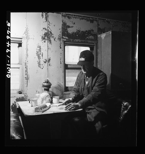 Conductor George E. Burton, having lunch in the caboose on the Atchison, Topeka, and Santa Fe Railroad between Chicago and Chillicothe, Illinois