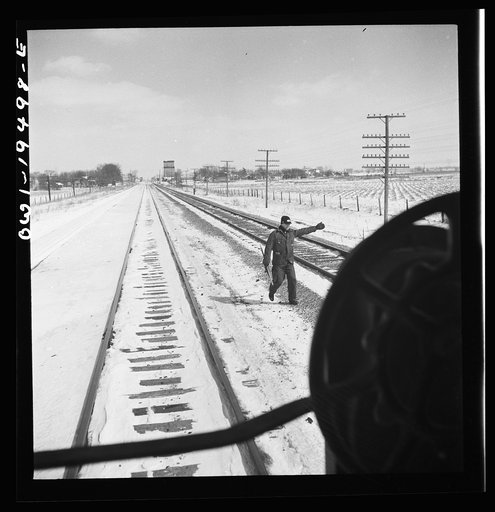 Untitled photo, possibly related to: Verona, Illinois. The brakeman gives the highball sign after the train on the Atchison, Topeka, and Santa Fe Railroad between Chicago and Chillicothe, Illinois