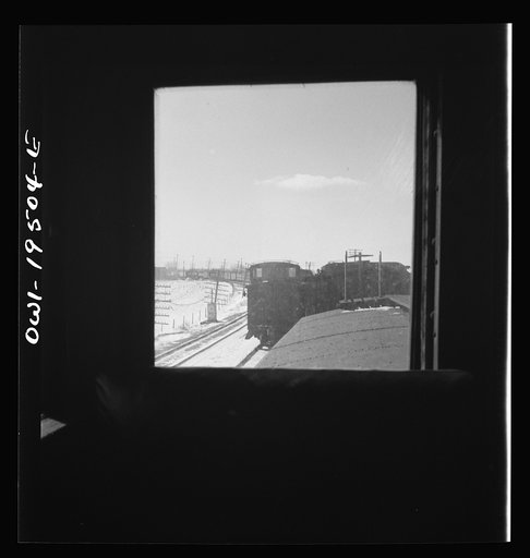 Untitled photo, possibly related to: Streator (vicinity), Illinois. Passing an eastbound freight train on the Atchison, Topeka and Santa Fe Railroad between Chicago and Chillicothe, Illinois. Seen through the window of the cupola