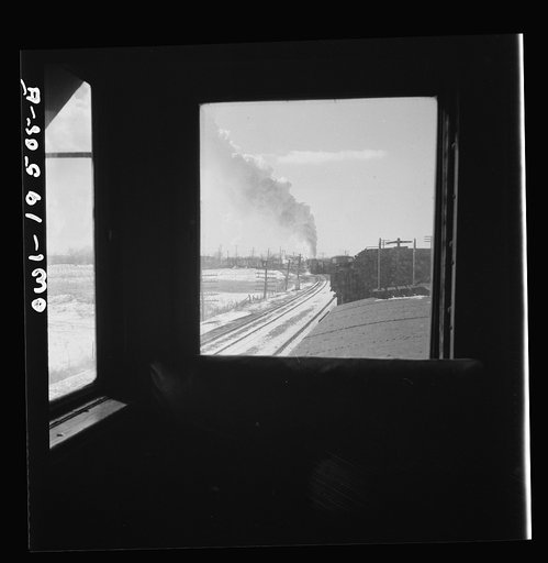 Streator (vicinity), Illinois. Passing an eastbound freight train on the Atchison, Topeka and Santa Fe Railroad between Chicago and Chillicothe, Illinois. Seen through the window of the cupola
