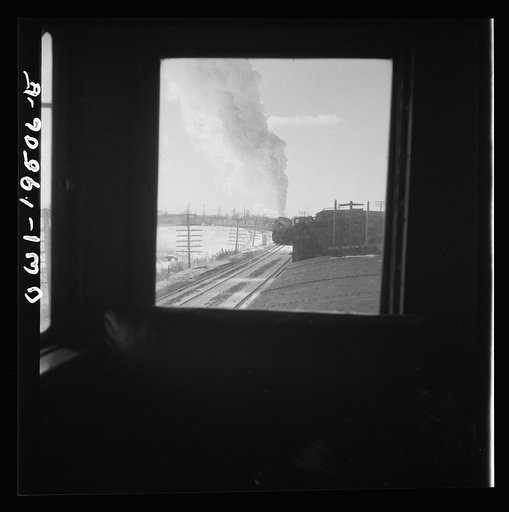 Untitled photo, possibly related to: Streator (vicinity), Illinois. Passing an eastbound freight train on the Atchison, Topeka and Santa Fe Railroad between Chicago and Chillicothe, Illinois. Seen through the window of the cupola