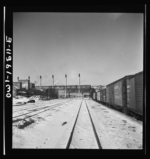 Streator, Illinois. Going through the Atchison, Topeka and Santa Fe Railroad yard. In the background is a large bottling works