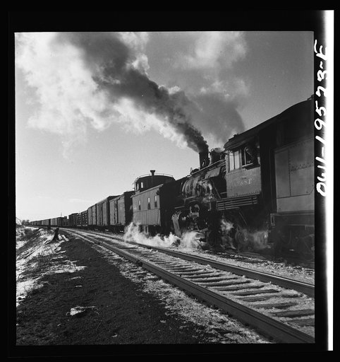 Untitled photo, possibly related to: Chillicothe, Illinois. Changing crews and cabooses of a westbound freight train along the Atchison, Topeka and Santa Fe Railroad, between Chicago and Chillicothe, Illinois