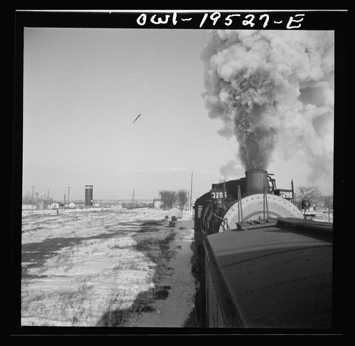 Untitled photo, possibly related to: Chillicothe, Illinois. A helper engine is taken on for added power on a grade extending eight miles on the Atchison, Topeka and Santa Fe Railroad, between Chillicothe, Illinois and Fort Madison, Iowa