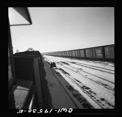 Untitled photo, possibly related to: Streator, Illinois. Going through the Atchison, Topeka and Santa Fe Railroad yard. In the background is a large bottling works