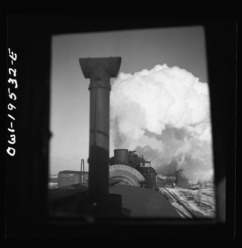 Untitled photo, possibly related to: Chillicothe, Illinois. A helper engine is taken on for added power on a grade extending eight miles on the Atchison, Topeka and Santa Fe Railroad, between Chillicothe, Illinois and Fort Madison, Iowa