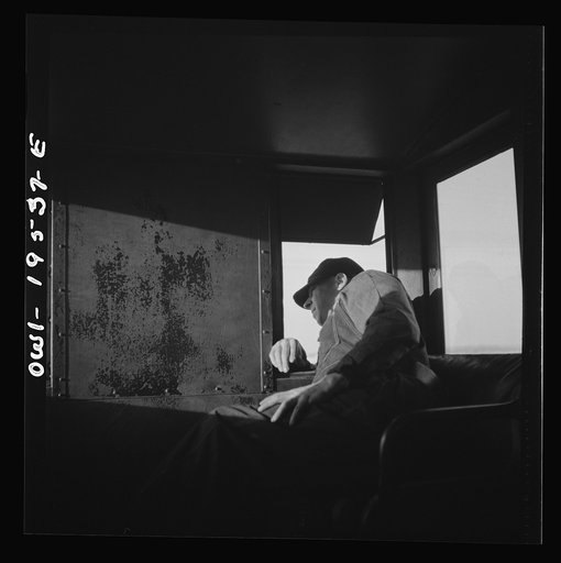 Rear brakeman M. H. Burdette, watching the train from his window in the cupola on the Atchison, Topeka and Santa Fe Railroad, between Chillicothe, Illinois and Fort Madison, Iowa