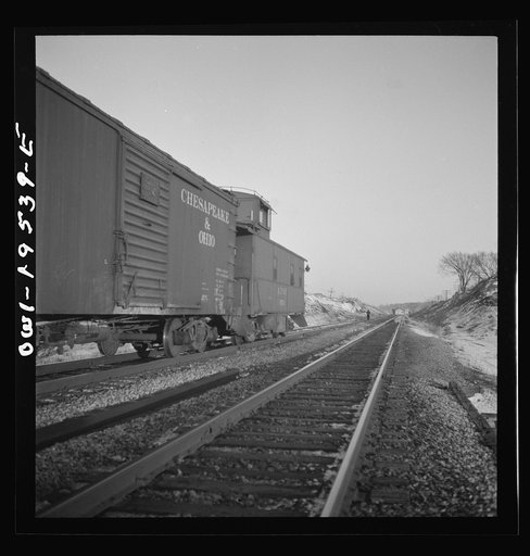 Dahinda, Illinois. A coupling pin jumps loose and the rear brakeman goes back to flag any oncoming trains on the Atchison, Topeka and Santa Fe Railroad between Chillicothe, Illinois and Fort Madison, Iowa