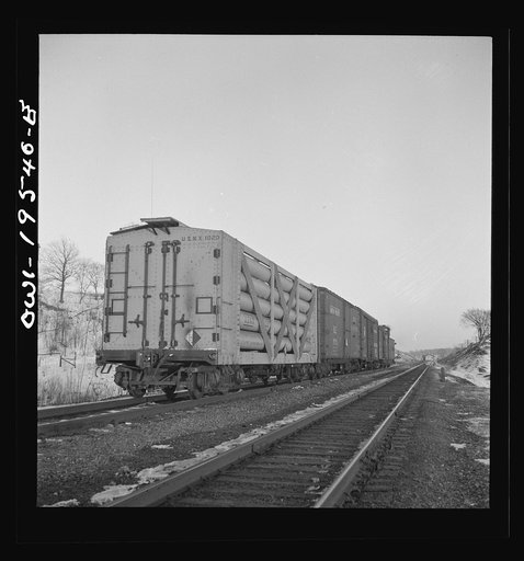 Untitled photo, possibly related to: Dahinda, Illinois. On the Atchison, Topeka and Santa Fe Railroad between Chillicothe, Illinois to Fort Madison, Iowa, a coupling pin jumps loose and the train breaks in two. The conductor, riding on top of the train, signals the engineer as they back up in order 