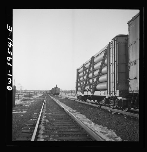 Untitled photo, possibly related to: Dahinda, Illinois. On the Atchison, Topeka and Santa Fe Railroad between Chillicothe, Illinois to Fort Madison, Iowa, a coupling pin jumps loose and the train breaks in two. The conductor, riding on top of the train, signals the engineer as they back up in order 