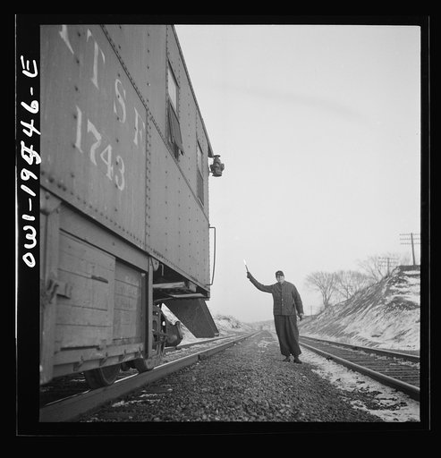Dahinda (vicinity), Illinois. The flagman gives the highball sign as the train is ready to start again on the Atchison, Topeka and Santa Fe Railroad between Chillicothe, Illinois and Fort Madison, Iowa