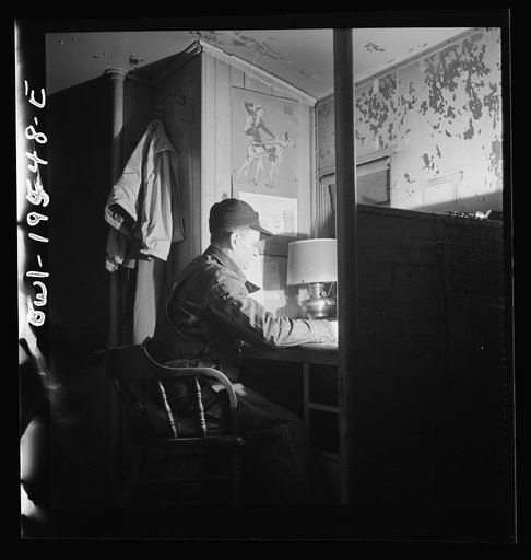 Untitled photo, possibly related to: A conductor studying a timetable in the caboose on the Atchison, Topeka and Santa Fe Railroad between Chillicothe, Illinois and Fort Madison, Iowa
