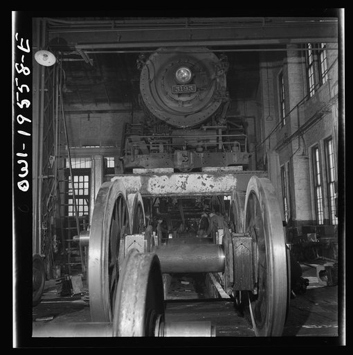 Untitled photo, possibly related to: Fort Madison, Iowa. Wheeling and engine in the locomotive shops of the Atchison, Topeka, and Santa Fe Railroad