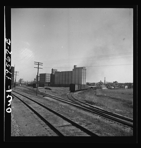 Alva, Oklahoma. Passing a grain elevator along the Atchison, Topeka and Santa Fe Railroad between Wellington, Kansas and Waynoka, Oklahoma