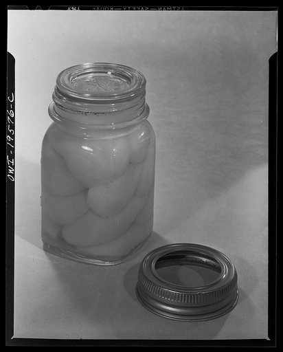 Steel-saving glass-top jars, recommended by the War Production Board, Containers Division, for home canning of the Victory garden fruits and vegetables in 1943. Let the jar stand for twelve hours by which time it will have cooled thoroughly. After this the screw bands may be removed permanently sinc