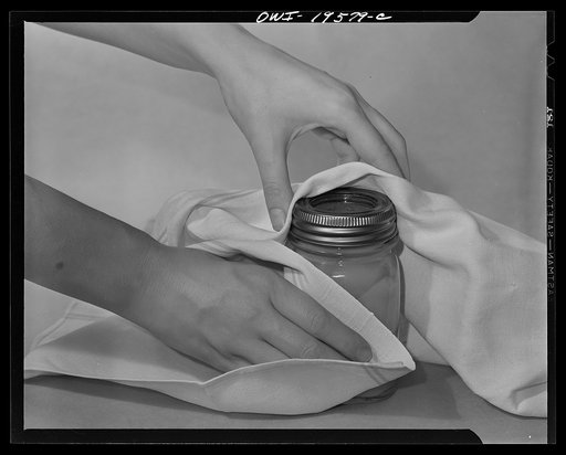 Steel-saving glass-top jars recommended by the War Production Board, Containers Division, for home canning of the Victory garden fruits and vegetables in 1943. Third step is to allow expanding air inside the jar to escape during the processing; the screw band should be turned as far as it will go an