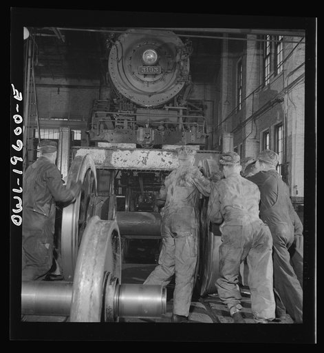 Fort Madison, Iowa. Wheeling an engine in the Shopton locomotive shops of the Atchison, Topeka, and Santa Fe Railroad