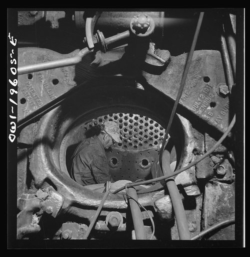 Fort Madison, Iowa. Boilermakers at work in the fire box at the Shopton locomotive shops of the Atchison, Topeka, and Santa Fe Railroad