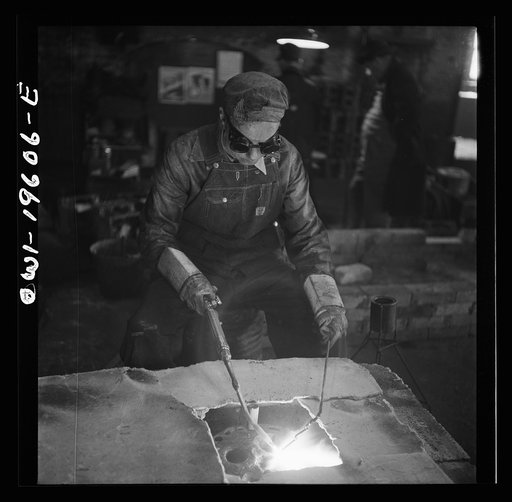 Fort Madison, Iowa. Welding cracks in the cylinder head of a diesel engine at the Shopton locomotive shops of the Atchison, Topeka, and Santa Fe Railroad