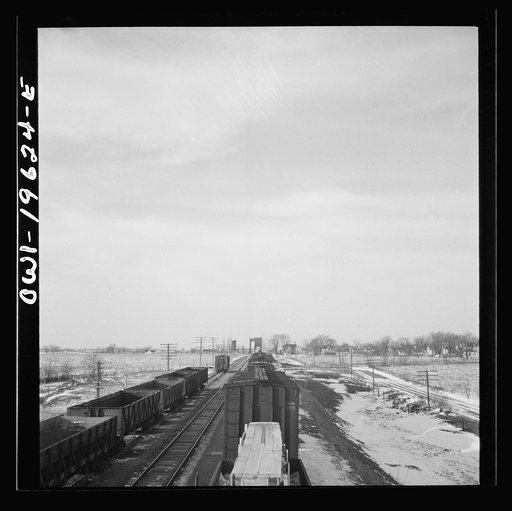 Untitled photo, possibly related to: Baring, Missouri. A train stopping for coal and water along the Atchison, Topeka, and Santa Fe Railroad between Fort Madison, Iowa and Marceline, Missouri