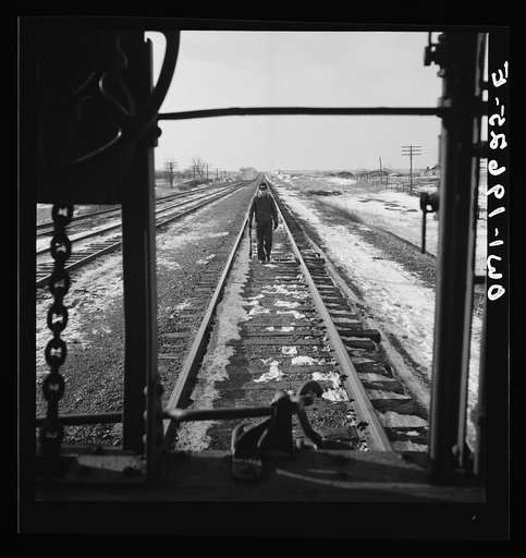 Baring, Missouri. A flagman returning to a train on the Atchison, Topeka, and Santa Fe Railroad, as it is about to start, after having taken on coal and water