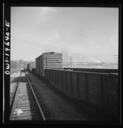 Untitled photo, possibly related to: The crew of a passing east-bound freight train on the Atchison, Topeka, and Santa Fe Railroad between Fort Madison, Iowa and Marceline, Missouri giving the highball sign