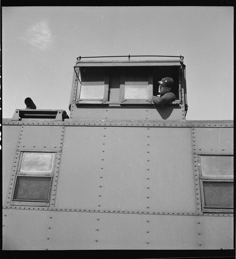 Marceline, Missouri. Brakeman in the cupola of his caboose in the Atchison, Topeka, and Santa Fe Railroad yard