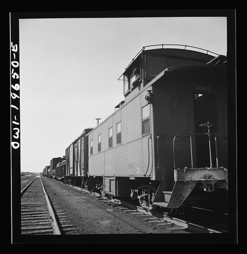 Untitled photo, possibly related to: Marceline, Missouri. Brakeman in the cupola of his caboose in the Atchison, Topeka, and Santa Fe Railroad yard