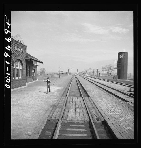 Henrietta, Missouri. Going through the town on the Atchison, Topeka, and Santa Fe Railroad between Marceline, Missouri and Argentine, Kansas. The operator has just handed up a message