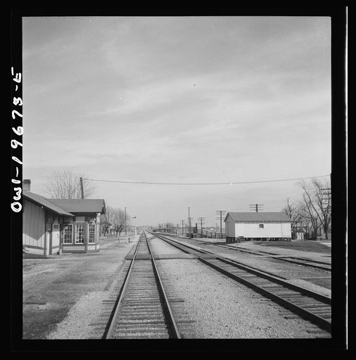 Floyd, Missouri. Going through the town on the Atchison, Topeka, and Santa Fe Railroad between Marceline, Missouri and Argentine, Kansas. The white building on the right is a potato barn