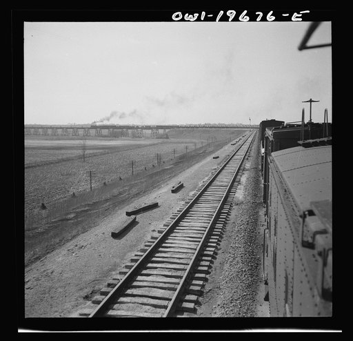 Untitled photo, possibly related to: Sibley, Missouri. A freight train on the Atchison, Topeka, and Santa Fe Railroad between Marceline, Missouri and Argentine, Kansas going across the Missouri river
