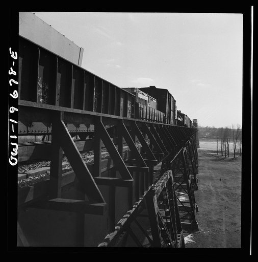 Untitled photo, possibly related to: Sibley, Missouri. A freight train on the Atchison, Topeka, and Santa Fe Railroad between Marceline, Missouri and Argentine, Kansas going across the Missouri river