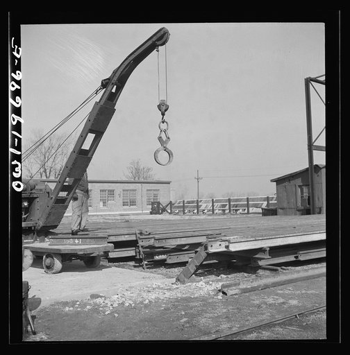 Untitled photo, possibly related to: Topeka, Kansas. Breaking rails which have been found defective by the rail doctor car, at the test department of the Atchison, Topeka, and Santa Fe Railroad shops. The rail is dropped so as to crack at the point marked by the chalk marked arrow. The extent of the