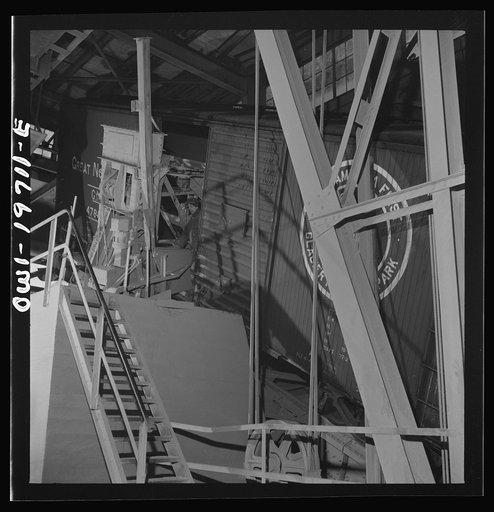 Untitled photo, possibly related to: Argentine, Kansas. A car dumper at the Atchison, Topeka, and Santa Fe Railroad's ten-million bushel grain elevator. These cars of wheat are unloaded by tilting the car so that wheat can run out of the door in the center