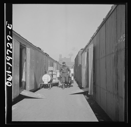 Untitled photo, possibly related to: Kansas City, Missouri. Loading and unloading cars at the Atchison, Topeka, and Santa Fe freight depot
