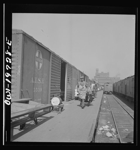 Kansas City, Missouri. Loading and unloading cars at the Atchison, Topeka, and Santa Fe freight depot