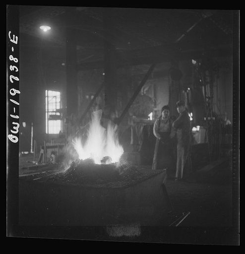 Untitled photo, possibly related to: Topeka, Kansas. A general view of the blacksmith shop of the Atchison, Topeka, and Santa Fe Railroad