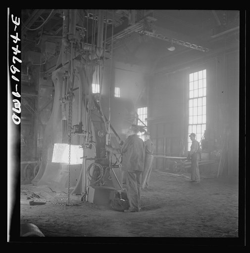 Topeka, Kansas. Hammering out a drawbar at the giant steam hammer in the blacksmith shop of the Atchison, Topeka, and Santa Fe Railroad