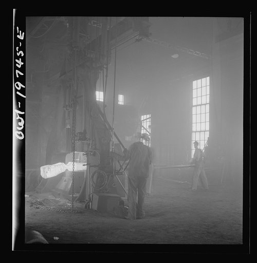 Untitled photo, possibly related to: Topeka, Kansas. Hammering out a drawbar at the giant steam hammer in the blacksmith shop of the Atchison, Topeka, and Santa Fe Railroad