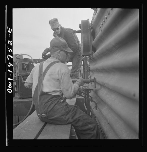 Topeka, Kansas. Bucking rivets on a freight car which is being rebuilt in the shops of the Atchison, Topeka and Santa Fe Railroad