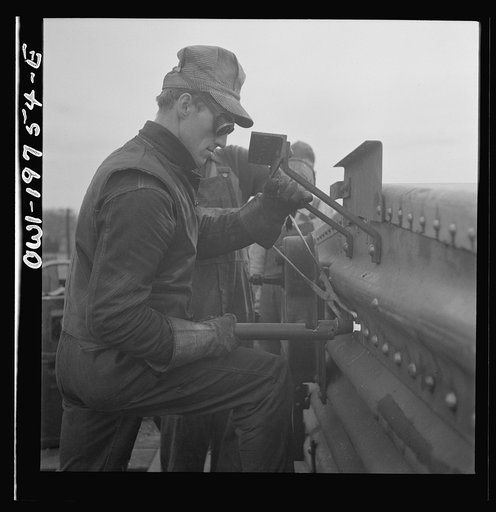 Topeka, Kansas. Bucking rivets on a freight car which is being rebuilt in the shops of the Atchison, Topeka and Santa Fe Railroad