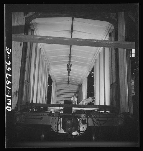 Untitled photo, possibly related to: Topeka, Kansas. Working on a special car for the transportation of airplane wings in the shops of the Atchison, Topeka and Santa Fe Railroad. These cars are constructed with doors at one end