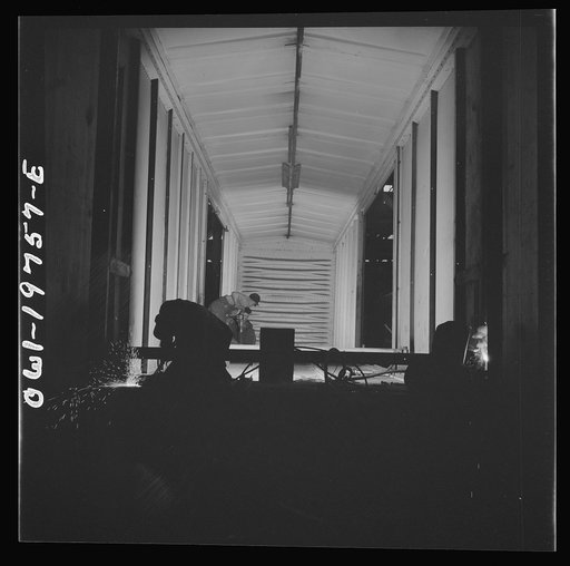 Topeka, Kansas. Working on a special car for the transportation of airplane wings in the shops of the Atchison, Topeka and Santa Fe Railroad. These cars are constructed with doors at one end
